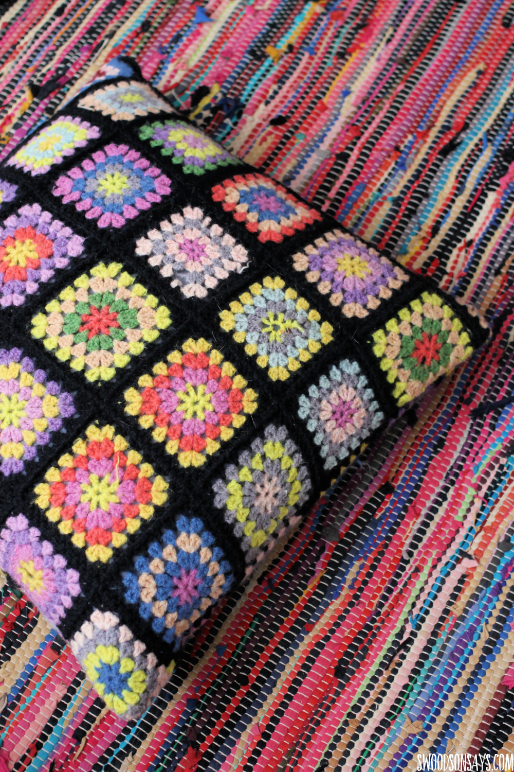 colorful crochet blanket turned into a pillow cover